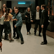 a group of people are standing in a hallway and one of them is dancing