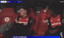 two soccer players wearing red jerseys with the word armenia on them