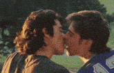 a couple of men kissing with one wearing a jersey that says a on it