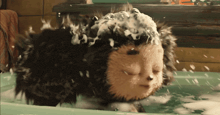 a stuffed animal is taking a bath in a tub
