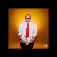 a man in a white shirt and red tie stands in front of an orange background