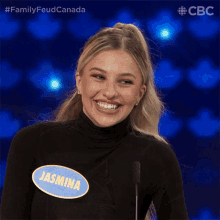 a woman with a name tag that says jasmina is smiling