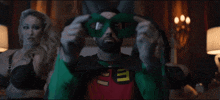 a man in a robin costume has a green mask on his eyes