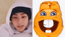 a man wearing a hat and a hoodie next to a cartoon smiley face with a big mouth .