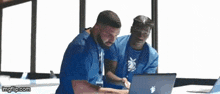 two men are looking at a laptop with imgflip.com written on the bottom