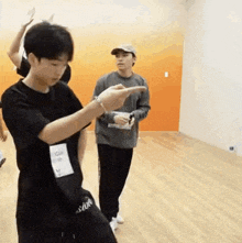 a group of young men are standing in a room .