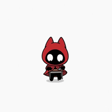 a cat with a red hood is sitting on a small table