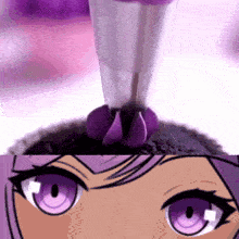a close up of a cupcake with purple frosting and a close up of a girl 's eyes