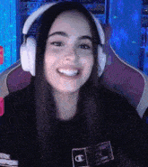 a woman wearing headphones and a shirt that says champion