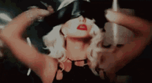 a close up of a woman wearing a blindfold with the letters cx on the bottom right