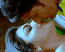 a man and a woman are kissing each other on the lips
