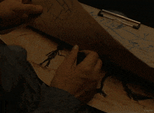 a person is drawing a monster on a piece of paper that says kepler on it