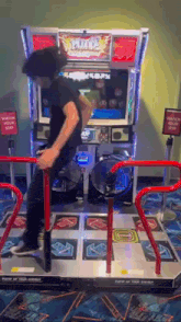 a man is playing a video game with a sign that says " watch your step "