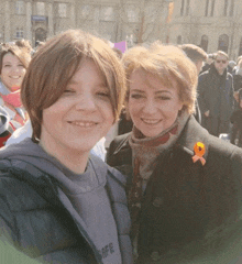 a boy wearing a hoodie that says safe poses for a picture with a woman