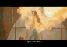 a woman is dancing in front of a large fire .