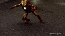 kermit the frog is wearing a red iron man costume