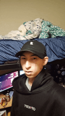 a young man wearing a hat and a hoodie with thrasher on it