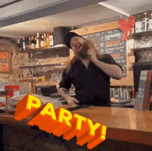 a man with a beard is standing behind a bar with the word party written on the counter
