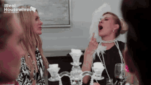 a group of women are sitting at a table with the words real housewives out of context on the top