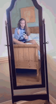 a girl is taking a selfie in a full length mirror