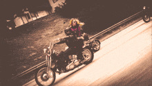 a man and a woman are riding motorcycles on a road