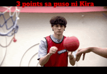 a man in a red jersey with the name josh on it holds a basketball