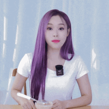 a woman with purple hair is sitting at a table