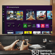 a person is playing a game on a samsung gaming hub