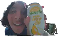 a man is holding a can of sunchy pear nectar lite in front of his face