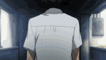 a man in a white shirt is standing in a dark room