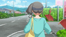 a woman in a blue shirt is walking down a street in front of a pink sign that says happy