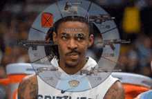 a man wearing a grizzlies jersey is surrounded by weapons