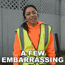 a woman wearing an orange hoodie and a yellow vest with the words a few embarrassing below her