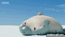 a seal is laying on its back on a beach with a blue sky behind it