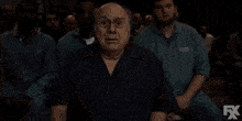 a man says i don 't get it ? in front of a crowd of people