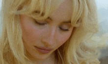 a close up of a blonde woman 's face