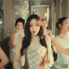 a woman in a corset is surrounded by other women and the word ms is on the bottom
