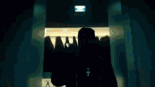 a man in a mask is standing in front of a door .