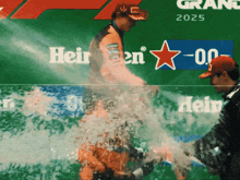 a man stands in front of a sign that says heineken on it