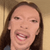 a close up of a woman making a funny face with her mouth open and big lips .