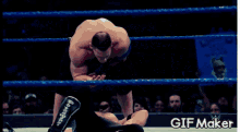 a gif of a wrestler doing a flip in a ring with the words gifmaker below it