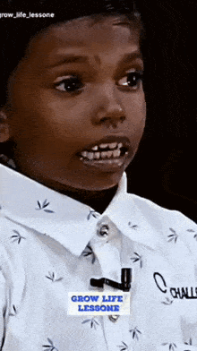 a young boy is wearing a shirt that says grow life lessone