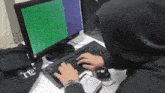 a person is typing on a keyboard in front of a computer screen that says " the "