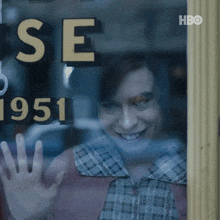 a woman is smiling in front of a sign that says " se 1951 "