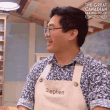 a man wearing glasses and an apron with stephen embroidered on it