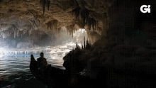 a group of people in a boat in a cave with the letter g on the bottom right