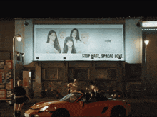 a billboard says stop hate spread love on it
