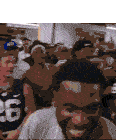 a man wearing a number 26 jersey is smiling in a crowd