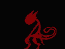 a red silhouette of a monster on a black background
