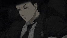 a man in a tuxedo has a badge on his jacket that says ' a ' on it